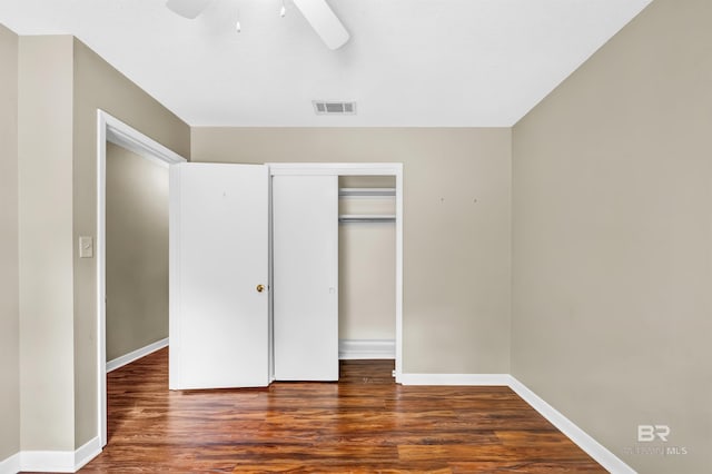 unfurnished bedroom featuring baseboards, visible vents, wood finished floors, and a closet