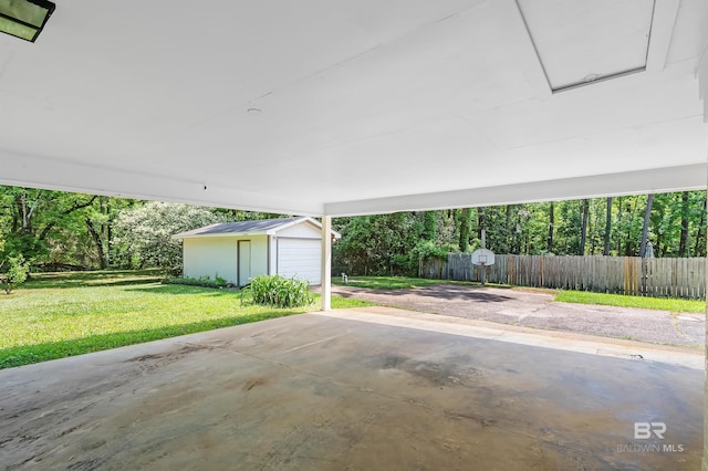view of patio with fence, a carport, and an outbuilding