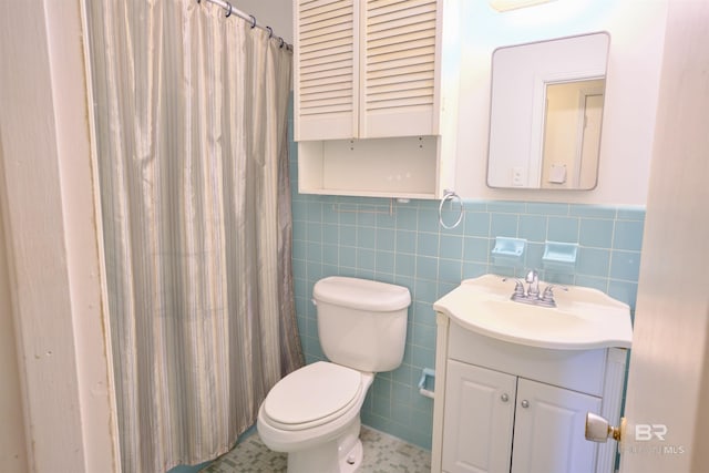 bathroom with vanity, tile walls, a shower with shower curtain, and toilet