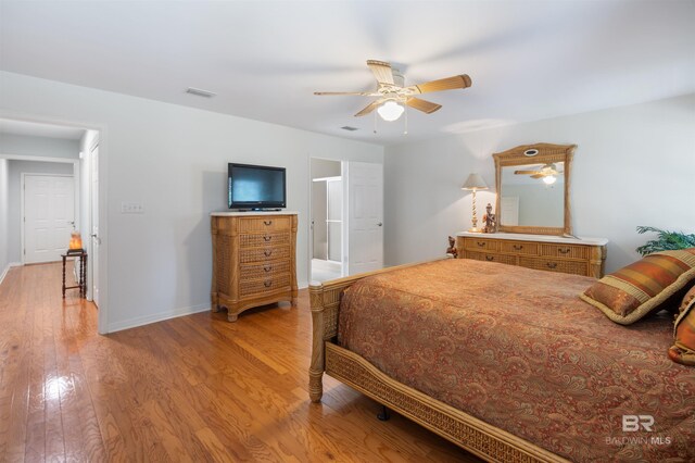 bedroom with light hardwood / wood-style floors and ceiling fan