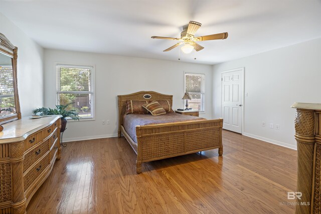 bedroom with hardwood / wood-style flooring and ceiling fan