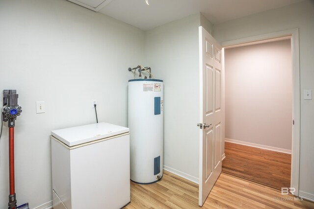 laundry room featuring light hardwood / wood-style flooring and water heater