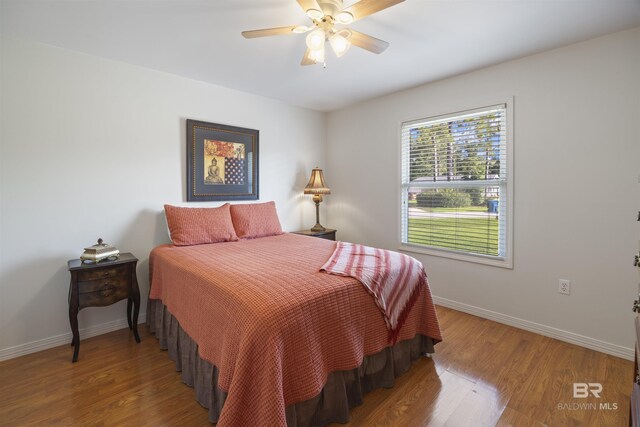 bedroom featuring hardwood / wood-style flooring and ceiling fan