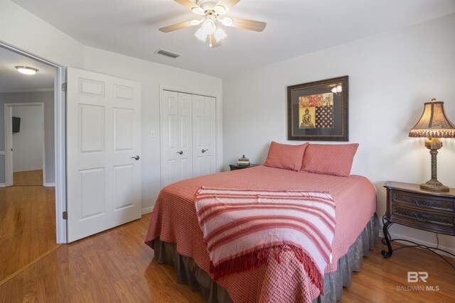 bedroom with a closet, ceiling fan, and hardwood / wood-style flooring