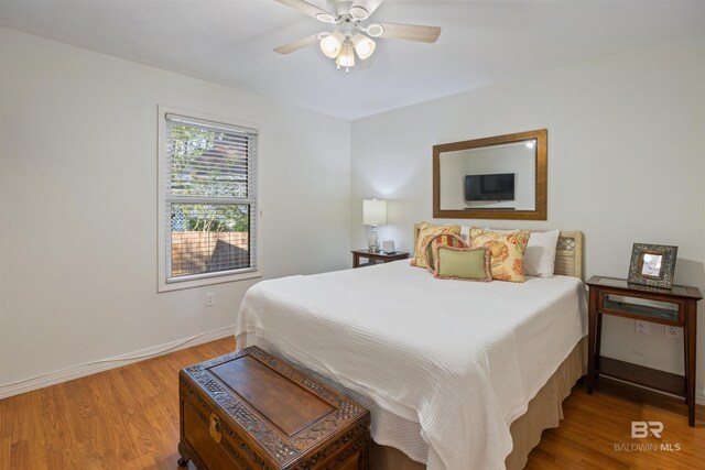 bedroom featuring hardwood / wood-style floors and ceiling fan