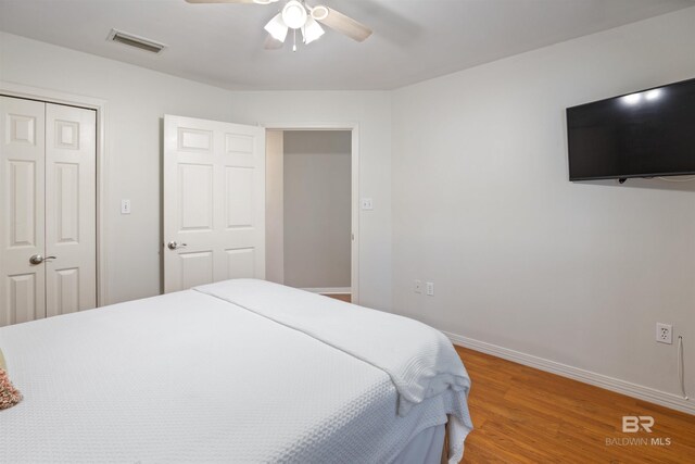 bedroom with a closet, ceiling fan, and hardwood / wood-style floors