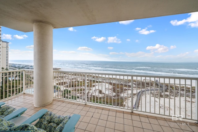 balcony with a water view and a beach view