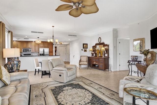 living area with ornamental molding, ceiling fan with notable chandelier, visible vents, and light tile patterned floors