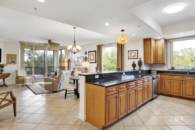 kitchen featuring light tile patterned floors, decorative backsplash, brown cabinetry, open floor plan, and stainless steel dishwasher