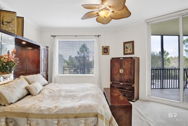 carpeted bedroom with access to outside, ornamental molding, and a ceiling fan