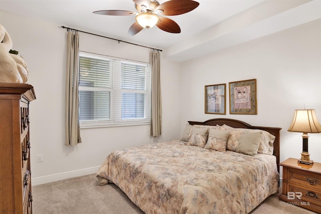 bedroom featuring light carpet, ceiling fan, and baseboards