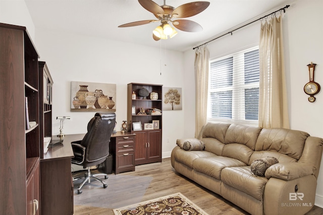 office area with light wood-style floors and a ceiling fan