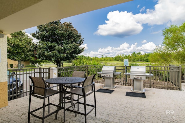 view of patio with outdoor dining area and a grill