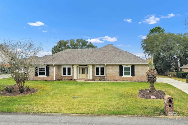 ranch-style house with brick siding, a shingled roof, and a front yard