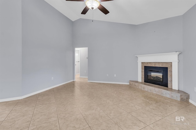 unfurnished living room with baseboards, ceiling fan, tile patterned floors, vaulted ceiling, and a fireplace