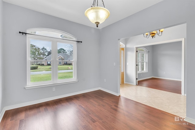 unfurnished room featuring baseboards and wood finished floors