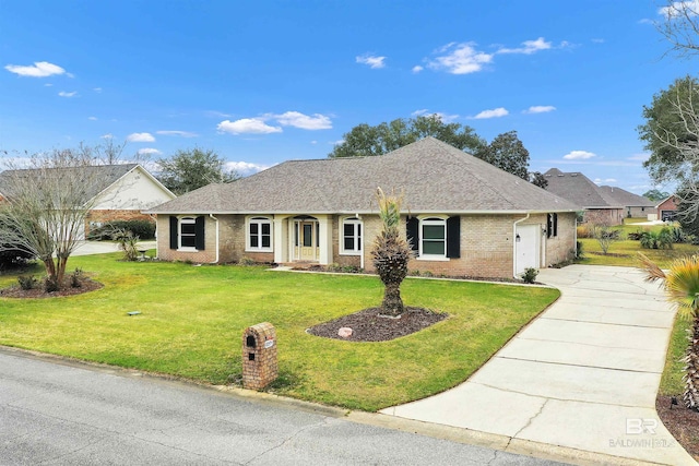 ranch-style home with a garage, concrete driveway, roof with shingles, a front lawn, and brick siding