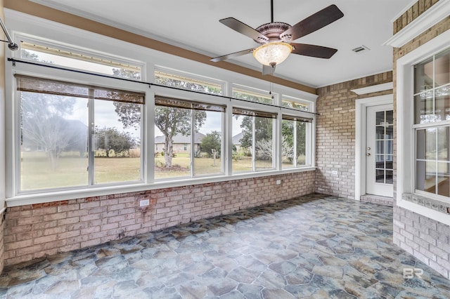 unfurnished sunroom featuring ceiling fan and visible vents