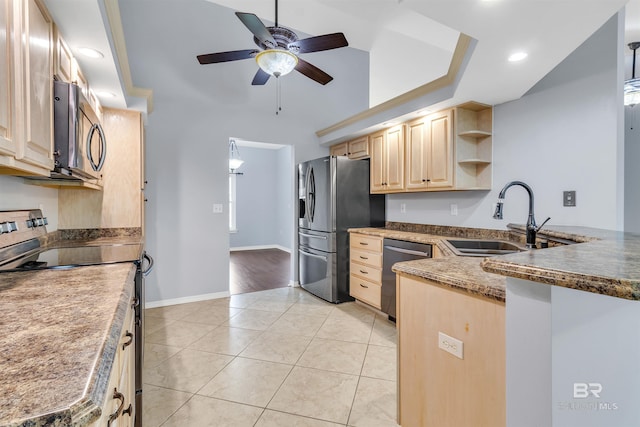 kitchen featuring appliances with stainless steel finishes, a peninsula, light brown cabinetry, a sink, and light tile patterned flooring