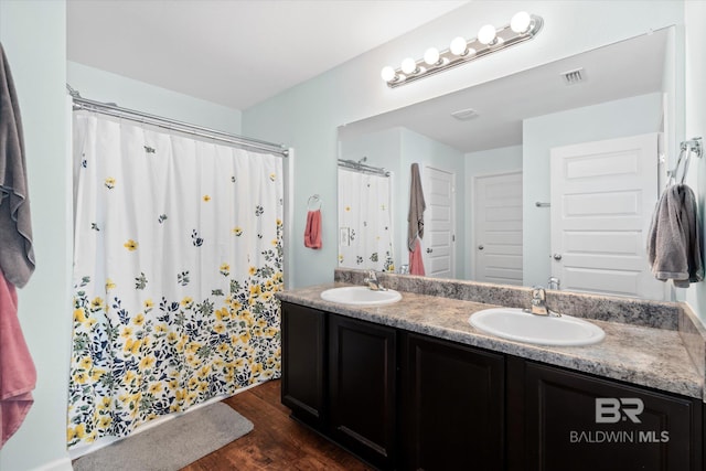 17372 Tallasee Blvd, Foley, AL 36535 - bathroom featuring wood finished floors, double vanity, and curtained shower