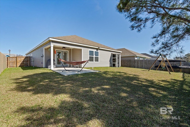 17372 Tallasee Blvd, Foley, AL 36535 - back of property featuring a fenced backyard, a patio area, a playground, and a ceiling fan
