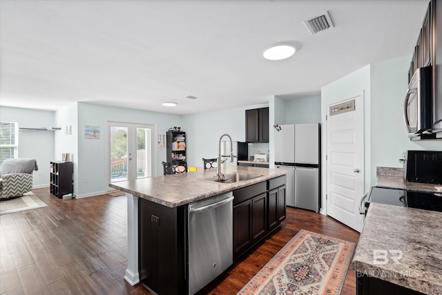 17372 Tallasee Blvd, Foley, AL 36535 - kitchen with appliances with stainless steel finishes, open floor plan, dark wood-style flooring, an island with sink, and french doors