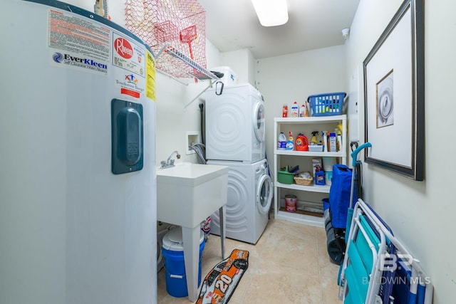 laundry area featuring stacked washer and dryer, electric water heater, light tile floors, and washer hookup