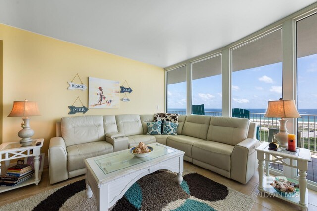 living room with floor to ceiling windows and a water view