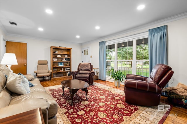 living room featuring ornamental molding and hardwood / wood-style floors