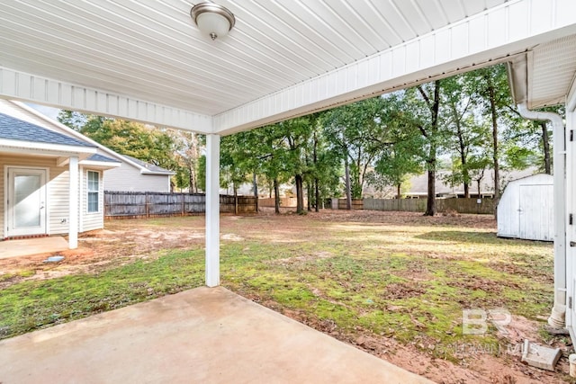 view of yard featuring a storage shed and a patio area