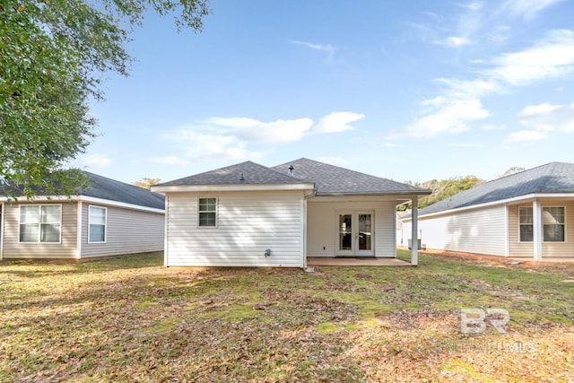 rear view of property with a lawn