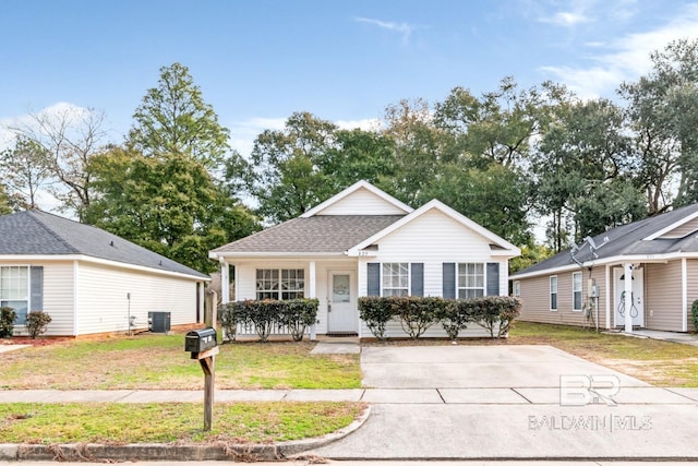 view of front of property with a front yard and central air condition unit