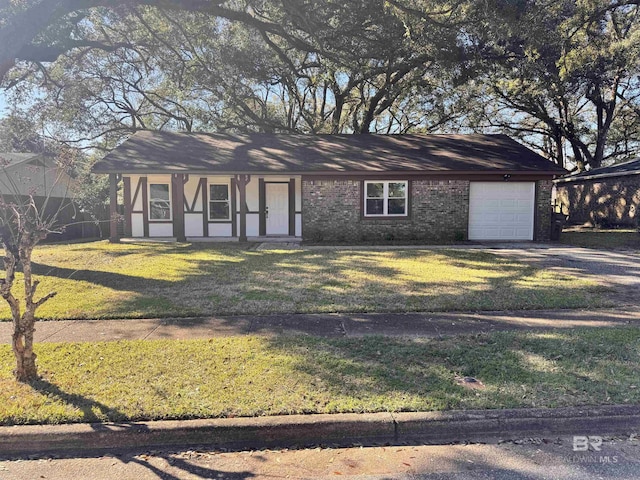 view of front of property featuring driveway, a front lawn, an attached garage, and brick siding