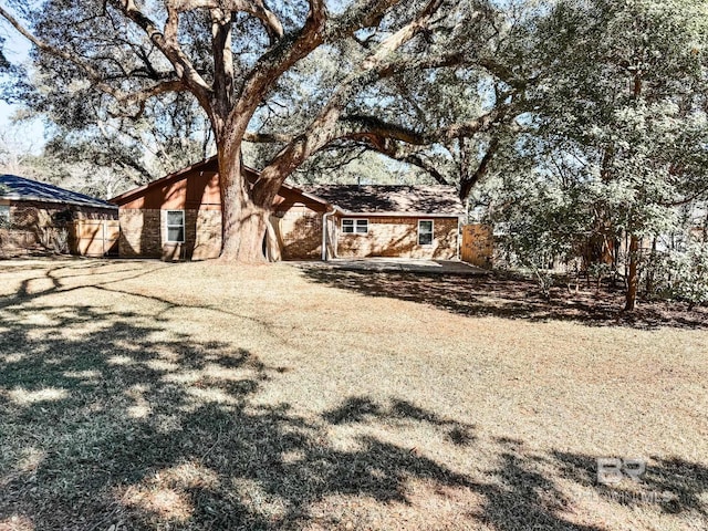 view of front facade featuring stone siding and fence