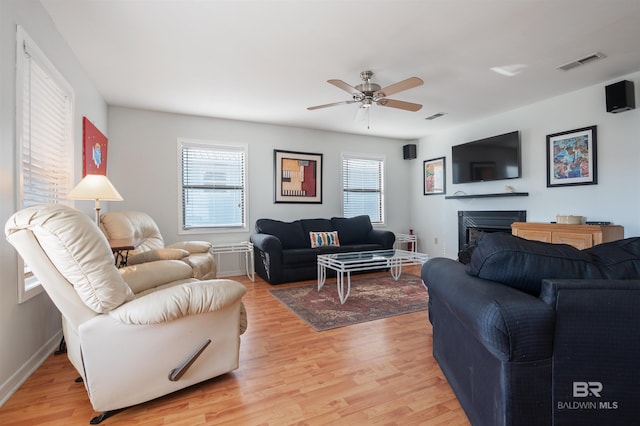 living room with ceiling fan, a healthy amount of sunlight, and light hardwood / wood-style floors