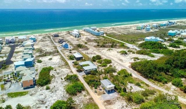 birds eye view of property featuring a water view and a beach view