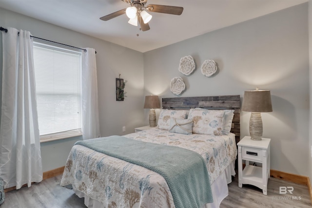 bedroom with ceiling fan and light wood-type flooring