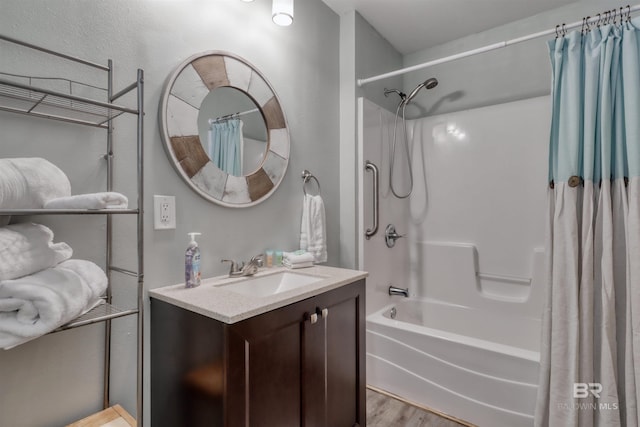bathroom with vanity, hardwood / wood-style flooring, and shower / bath combo with shower curtain