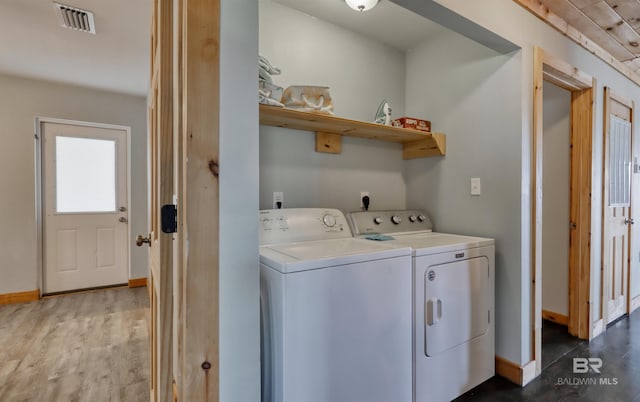 washroom featuring separate washer and dryer and hardwood / wood-style flooring