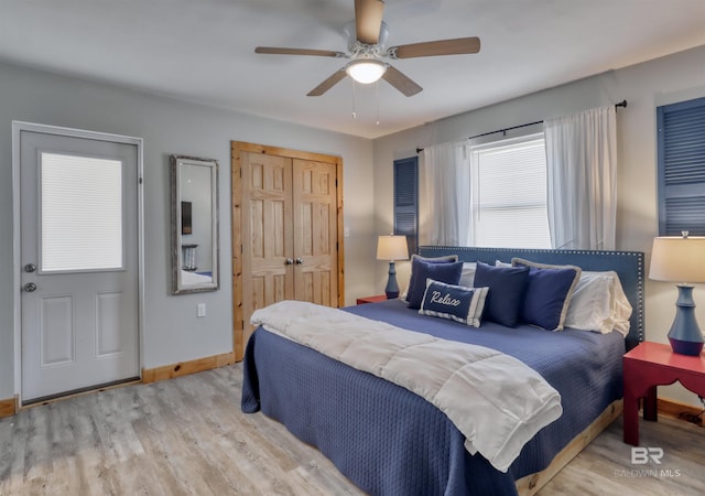 bedroom featuring light wood-type flooring, a closet, and ceiling fan