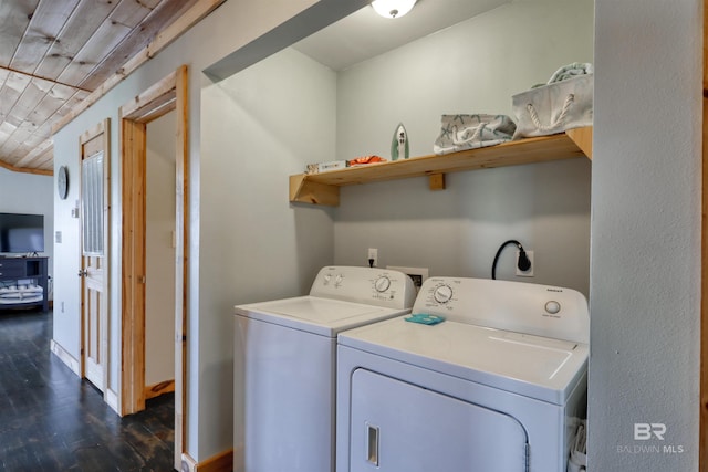 clothes washing area featuring dark wood-type flooring, washer and clothes dryer, and wooden ceiling