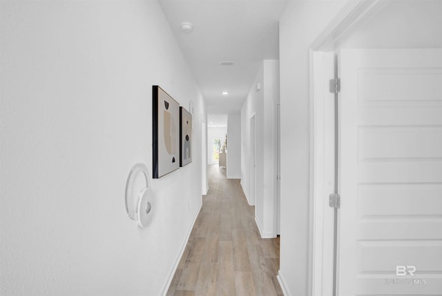 hallway with light hardwood / wood-style flooring