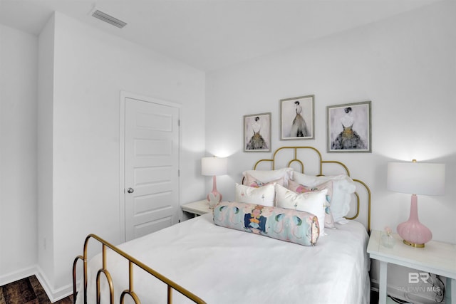 bedroom featuring dark hardwood / wood-style flooring