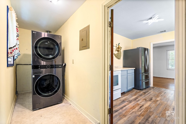 4014 Moffett Ct, Mobile, AL 36618 - washroom with stacked washer and clothes dryer, electric panel, baseboards, and wood finished floors