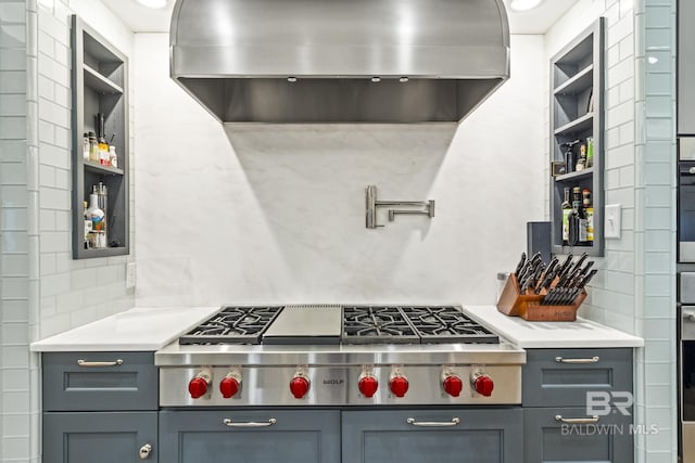 kitchen featuring tasteful backsplash, appliances with stainless steel finishes, gray cabinets, ventilation hood, and open shelves