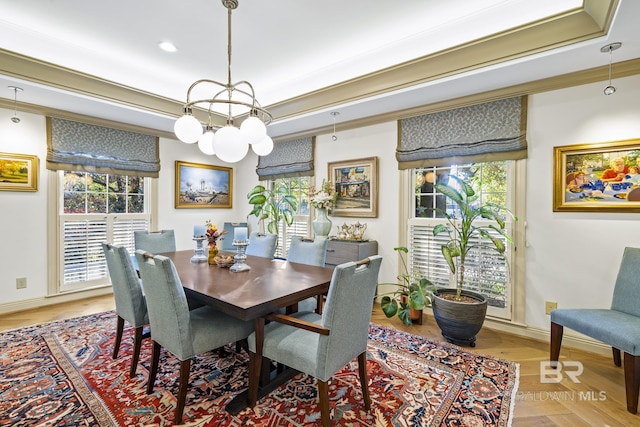 dining space featuring baseboards, light wood-style flooring, and crown molding