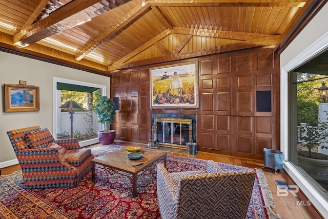 living area with a high end fireplace, wood ceiling, a healthy amount of sunlight, and lofted ceiling with beams