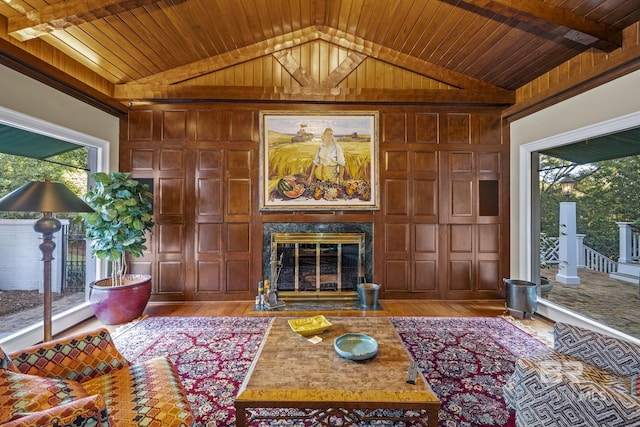 living area with vaulted ceiling, wooden ceiling, and a fireplace