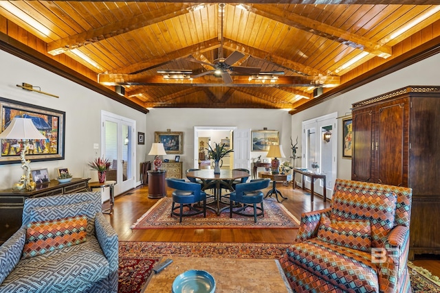 living area featuring vaulted ceiling with beams, wooden ceiling, and wood finished floors