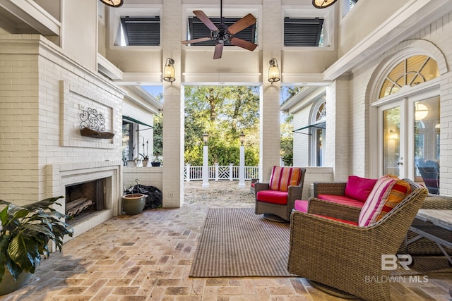 view of patio / terrace featuring an outdoor living space with a fireplace and fence